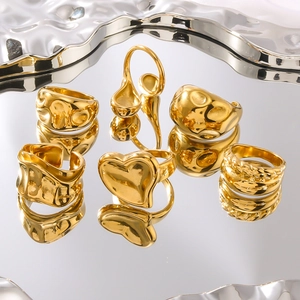 Set of 7 chunky gold titanium steel rings with irregular molten heart and wavy designs