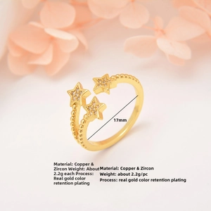 Detail of adjustable gold ring featuring three stars pavé-set with white zircon stones