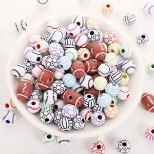 Macro detail of assorted acrylic sports beads including football and baseball for DIY jewelry