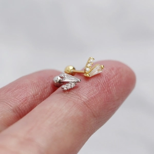 Detailed close-up of V-shaped sterling silver stud earrings with sparkling crystals
