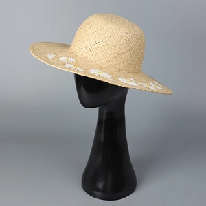 Women's Raffia straw sun hat with white daisy floral accents and wide brim for summer