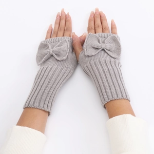 Close-up of grey knitted fingerless gloves with bow detail and ribbed cuffs for women