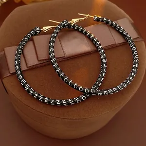 Retro round leather hoop earrings with letter print on velvet jewelry display box