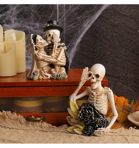Detailed view of resin skeleton couple figurines with gothic Halloween decor elements