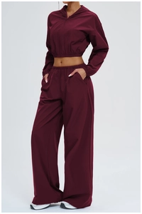 Detail of wine red lightweight hooded jacket and wide-leg trousers sports set