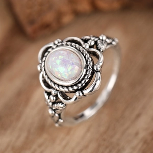 Vintage bohemian silver ring with oval fire opal and intricate floral filigree patterns