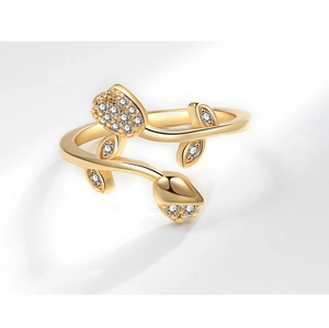 Macro detail of tulip flower ring with sparkling cubic zirconia on a gold open band