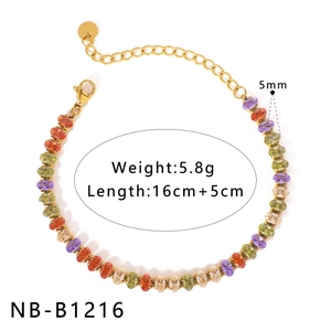 Detail of colorful oval gemstone bracelet with gold chain and lobster clasp