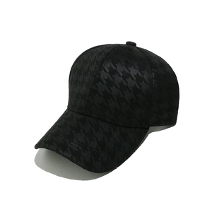 Detail of black houndstooth pattern texture on a structured baseball cap with six panels