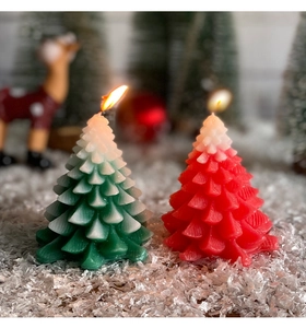 Close-up of red and green Christmas tree scented candles with snow detail on top
