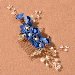 Detail of pink and blue fabric flowers bridal hair comb set with pearls and gold leaves