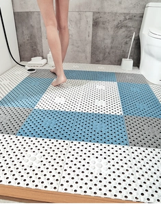 Detailed view of non-slip TPE bathroom mats with drainage holes and textured surface