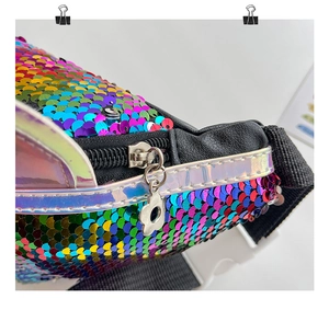 Detail of colorful sequin kids bag showing laser-cut trim and silver floral zipper pull