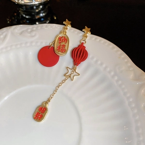 Detail of red and gold Chinese New Year tassel earrings with traditional fortune charms