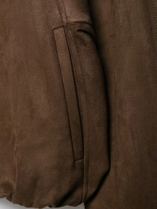 Detail shot of brown faux suede jacket showing precision stitching and fabric texture