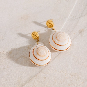 Detail of surgical steel stud earrings with natural spiral conch shell pendants
