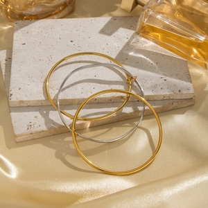 Minimalist gold and silver mixed color geometric bangle set on silk and stone background