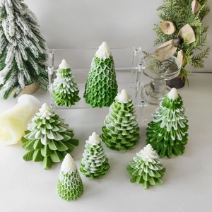 Green and white Christmas tree candles in various sizes for festive holiday decoration