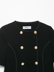 Detailed view of double-breasted black blazer with vintage gold buttons and fine fabric texture
