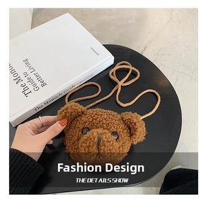 Close-up of brown plush bear crossbody bag with soft textured fabric and detailed embroidery