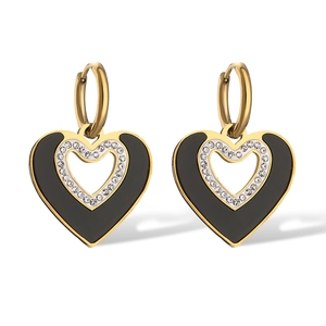 Elegant gold heart earrings with black enamel and zircon accents on white background
