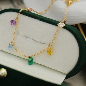 Macro shot of colorful cubic zirconia stones on an 18K gold-plated stainless steel bracelet