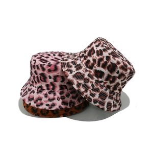 Three leopard print bucket hats in pink, brown, and orange displayed on white background