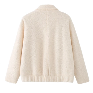 Detail view of the back of a cream white wool jacket with high-quality textured fabric