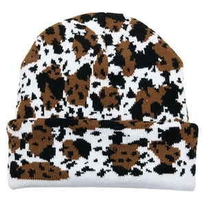 Knitted leopard print beanie hat with brown and black jacquard pattern on white background