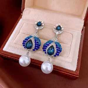 Elegant silver-toned waterdrop earrings with blue rhinestones and large white pearls