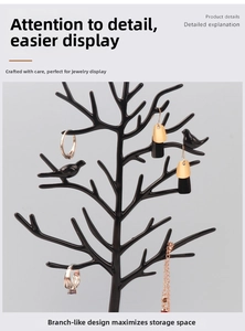 Detailed view of black tree-shaped jewelry stand organizer for necklaces and earrings