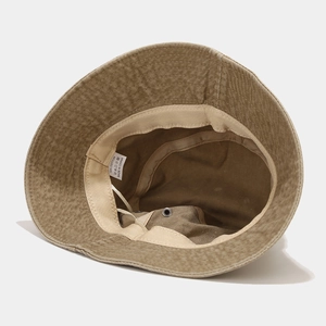 Detailed interior of khaki washed cotton bucket hat showing sweatband and 100% cotton label