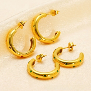 Detail of C-shaped gold-plated hoop earrings featuring colorful inlaid zircon crystals