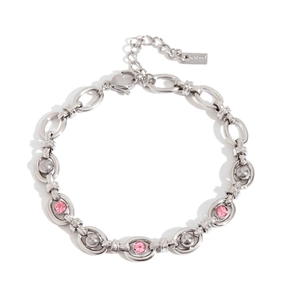 Detail of silver stainless steel bracelet with three pink stones and adjustable chain