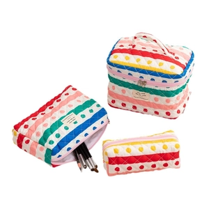 Three-piece colorful quilted cotton storage set with vibrant stripes and polka dots
