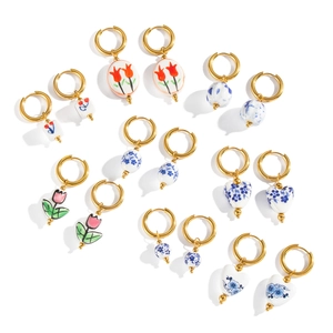 Vintage enamel ceramic flower earrings with tulip and blue floral patterns on gold hoops