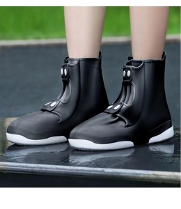 Waterproof silicone shoe covers in black with non-slip thickened soles on wet pavement