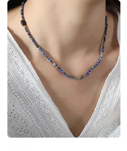 Detailed view of handmade necklace with blue lapis beads and natural faceted stones