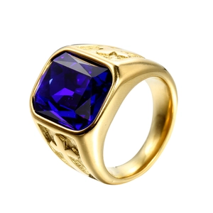 Macro detail of gold-tone ring featuring a large square blue gemstone with ornate relief