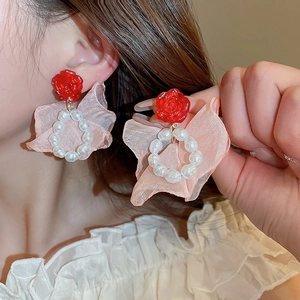 Detail of red rose earrings with white pearls and pink organza ribbon tassel for women
