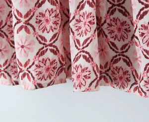 Close-up of floral print linen hem on women's skirt with detailed woven fabric texture