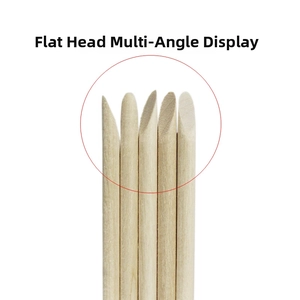 Macro detail of natural orange wood cuticle sticks showing the flat head nail tool edge