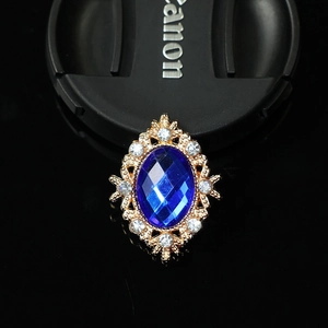Detailed view of vintage oval blue gemstone alloy brooch with sparkling rhinestones