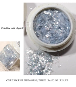 Macro shot of blue-grey aurora opal nail glitter powder with holographic reflections