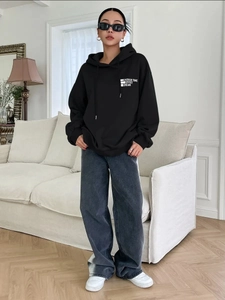 Women's American retro oversized black hoodie and grey jeans stylish streetwear outfit