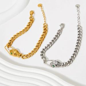 Luxury snake head Cuban link bracelet in gold and silver finish with green gemstone eyes