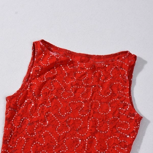 Detail of red sequined lace top featuring intricate hollow patterns and shimmering finish