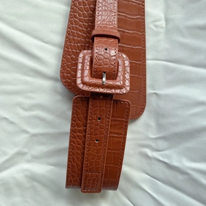 Wide brown crocodile pattern elastic waist belt for dresses on white fabric
