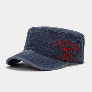 Close-up of red embroidered text on washed navy blue vintage flat top cotton cadet cap