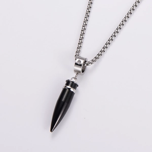 Detail shot of solid black bullet pendant necklace with sparkling crystal and silver chain